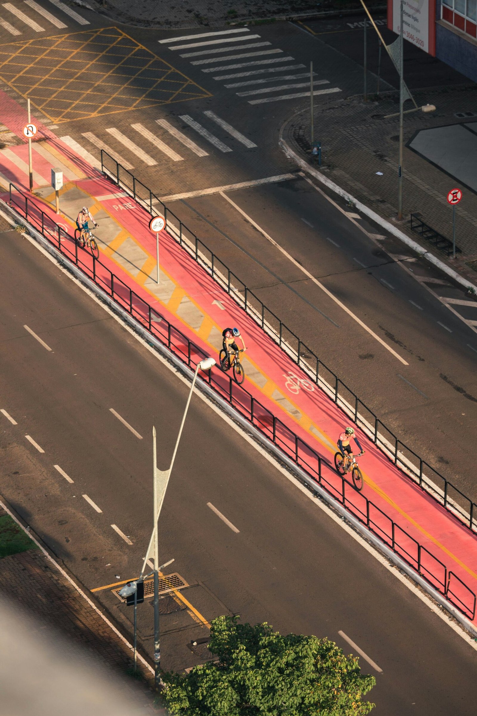 a group of bicyclists riding down a street