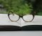 brown framed eyeglasses on book page