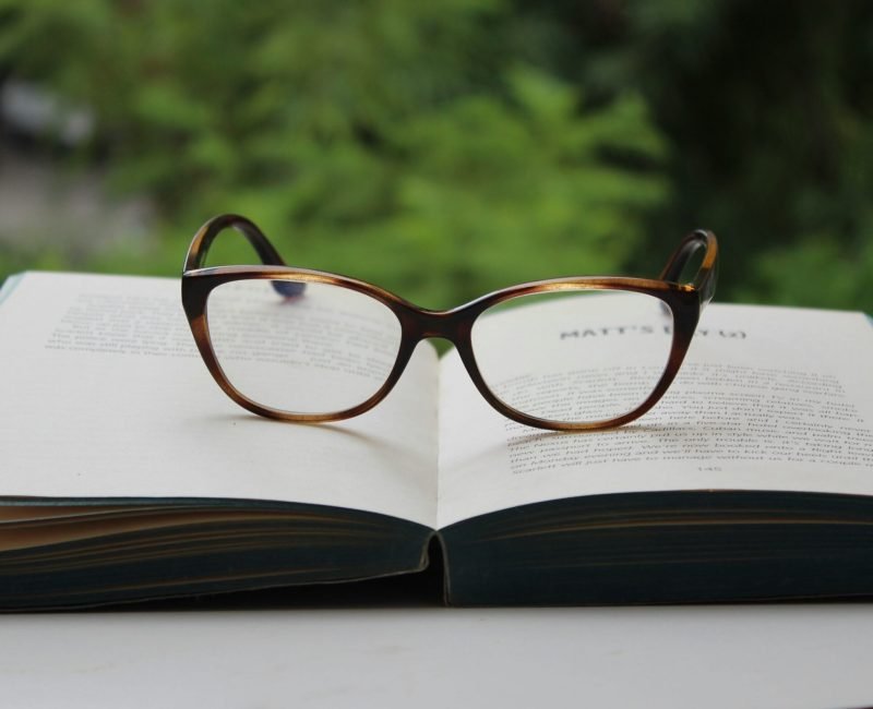 brown framed eyeglasses on book page